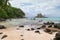 Tranquil bay with white sand, overcast skies, granite stones and turquoise sea at Fairyland Beach, Seychelles Africa.