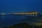 Tranquil beach scene illuminated by a dazzling array of lights of buildings