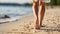 Tranquil beach travel scene closeup of a woman gracefully walking along the sandy shoreline