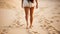 Tranquil beach travel serene woman walking barefoot on the golden sand beach closeup