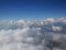 Tranquil Beautiful View From Plane Window at Blue Sky over White Clouds