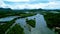 Tranquil body of water surrounded by lush greenery, providing a stunning contrast against cloudy sky