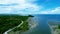 Tranquil body of water surrounded by lush greenery, providing a stunning contrast against cloudy sky