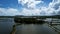 Tranquil body of water surrounded by lush greenery, providing a stunning contrast against cloudy sky