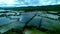 Tranquil body of water surrounded by lush greenery, providing a stunning contrast against cloudy sky