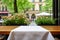 Tranquil cafe scene with empty table, crisp white tablecloth for serene moment, peaceful atmosphere