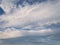 Tranquil cloudscape scene over the blue sky. Fluffy white clouds aerial composition. Misty overcast cumulus shapes, abstract