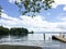 Tranquil coast scene with jetty and forested shore