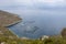 A tranquil coastal landscape with a seafood farm in a calm sea bay