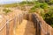 Tranquil Coastal Path with Wooden and Rope Fence at Beach, Guinch, Cabo da Roca.