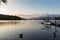 Tranquil dusk scene of mute swans and ducks swimming in Lake Windermere