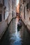 Tranquil gondola ride through narrow Venice canal with historic buildings