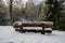 Tranquil Haven: Snow-Blanketed Bench in Pokainu Mezs\\\' Fir Woodland