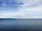 Tranquil lake with glistening blue water surrounded by majestic mountains in the distance