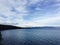 Tranquil lake with glistening blue water surrounded by majestic mountains in the distance