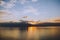 Tranquil lake illuminated by the setting sun, casting a mesmerizing reflection