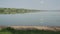 Tranquil Lake Landscape with Green Hills and Clear Sky