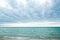 Tranquil Lake Michigan Beachscape with Gentle Waves and Cloudy Sky