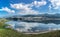 Tranquil lake reflecting the clouds and blue sky