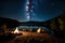 A tranquil lakeside campsite with a campfire, tents, and a clear night sky full of stars for stargazing