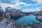 Tranquil landscape of an alpine lake, surrounded by majestic snow-covered mountains