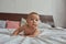 Tranquil little baby boy lying on tummy in bed