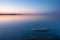 Tranquil minimalist landscape with rock in calm water