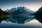 A tranquil, mirror-like lake reflecting a snow-covered mountain peak in its crystal-clear waters