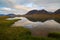 Tranquil morning arctic landscape. View of a small lake in the tundra.