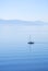 Tranquil morning sea with a sailing ship