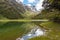 Tranquil mountain lake Mackenzie at the famous Routeburn Track, New Zealand