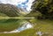 Tranquil mountain lake Mackenzie at the famous Routeburn Track, New Zealand