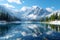 Tranquil mountain scene Lake nestled amid snowy peaks and trees