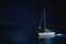 Tranquil night scene with a lonely illuminated yacht in the sea, marine scenery