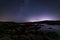 Tranquil nightscape of a Milky Way over Prescott Arizona, Watson Lake with mountains nearby