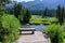 Tranquil outdoor setting with wood bench for contemplation on Soda Butte Creek, Yellowstone National Park, USA