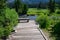 Tranquil outdoor setting with wood bench for contemplation on Soda Butte Creek, Yellowstone National Park, USA