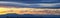 Tranquil panoramia scene of red sun and orange sky sunset over the Rocky Mountains in Colorado by Denver