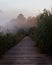 Tranquil path winding its way through a lush foggy meadow, creating a peaceful atmosphere.