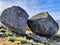 Tranquil path winding between two large rocks in the picturesque village of Monsanto, Portugal