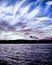 Tranquil peaceful white and lilac cirrus cloud, coastal sunset s