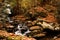 Tranquil, picturesque scene of a river, with large boulders scattered throughout the area