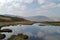 Tranquil reflections of the sky in a mountain lake tarn