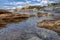 Tranquil rock pool with view to the waterfront