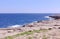 Tranquil rocky coastal line without people at winter in Marsaskala, Malta