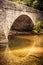 Tranquil scene of an arched stone bridge