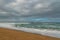 Tranquil scene. Empty sand beach and dramatic cloudy sky background