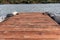 Tranquil scene of a wooden dock with a majestic lake in the background