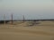 Tranquil scenery of overhead power lines in the sand desert on a gloomy day