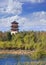 Tranquil scenery with a pagoda, trees and dramatic clouds at Chanchun wetlands